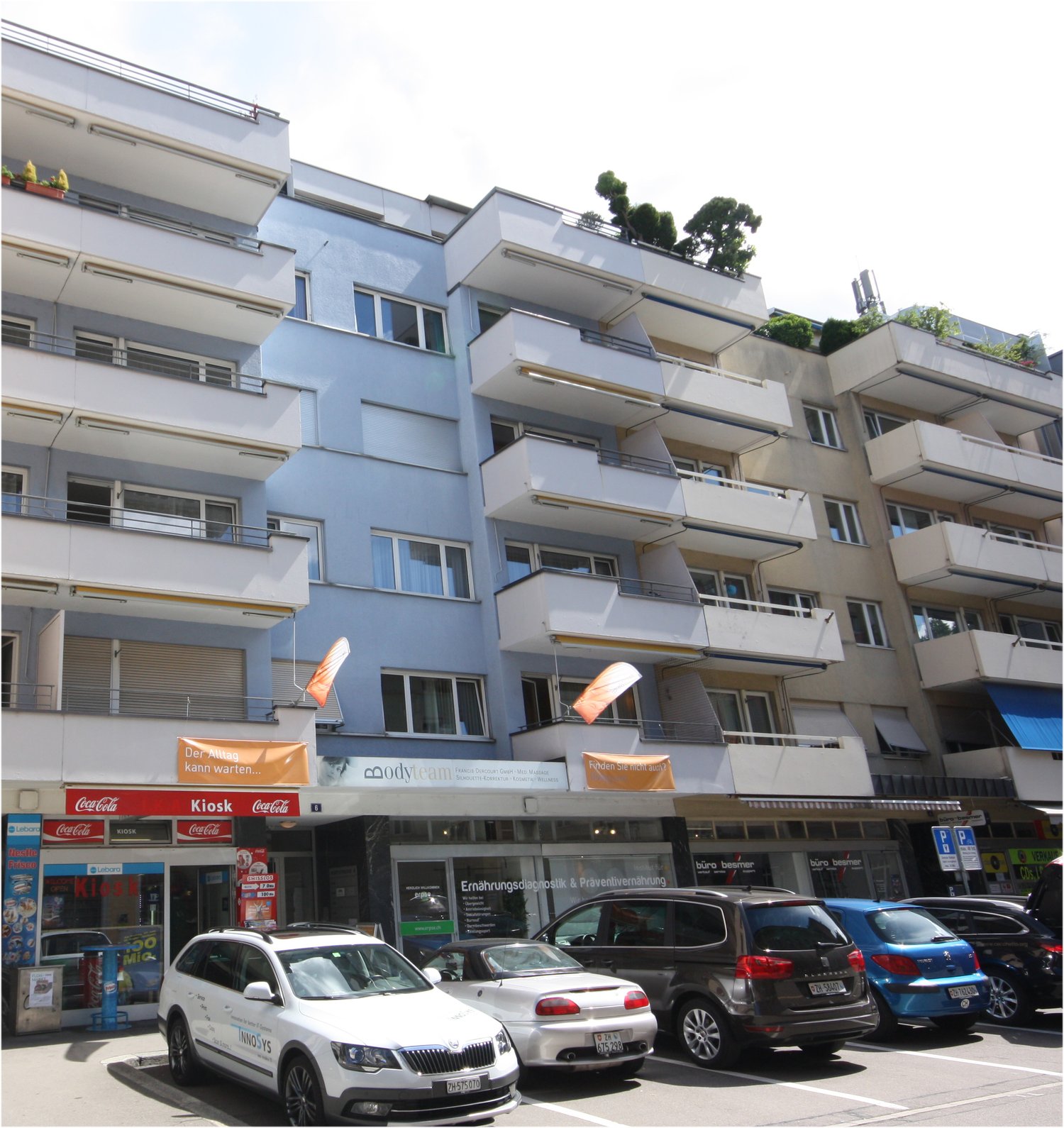 multi-story building, balcony, parking lot