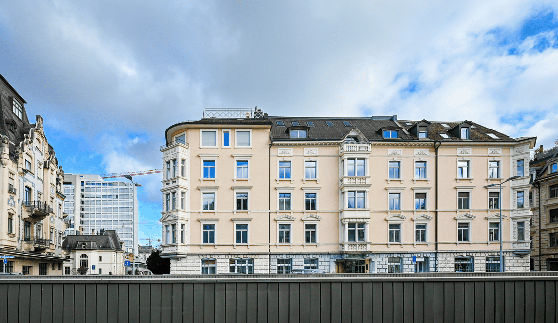 5 story building, beige facade, multiple windows, modern architecture