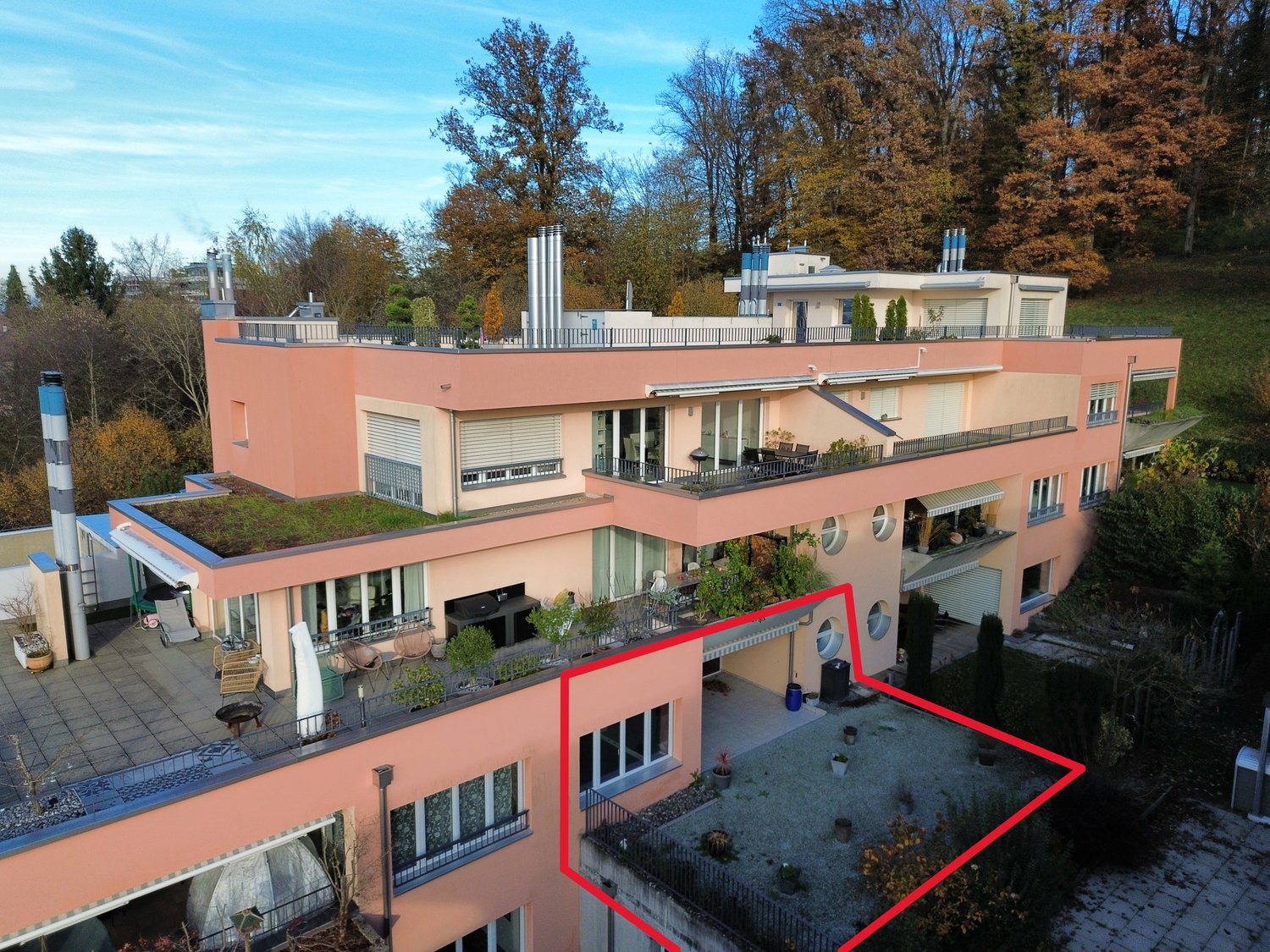 3-story house, pink exterior, large balcony on the top floor, swimming pool, terrace with garden, chimney, multiple windows, green rooftop, highlighted in red