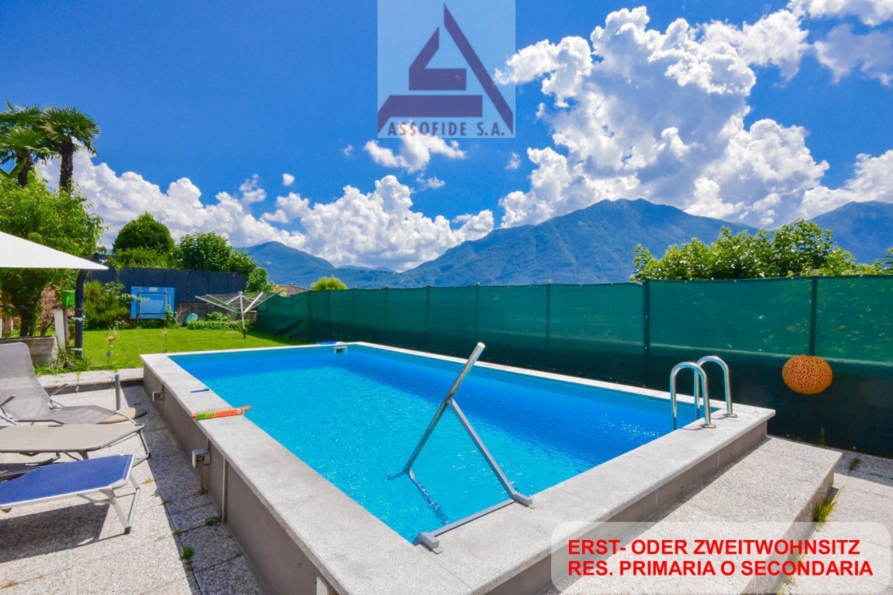 An outdoor swimming pool with a view of the mountains.