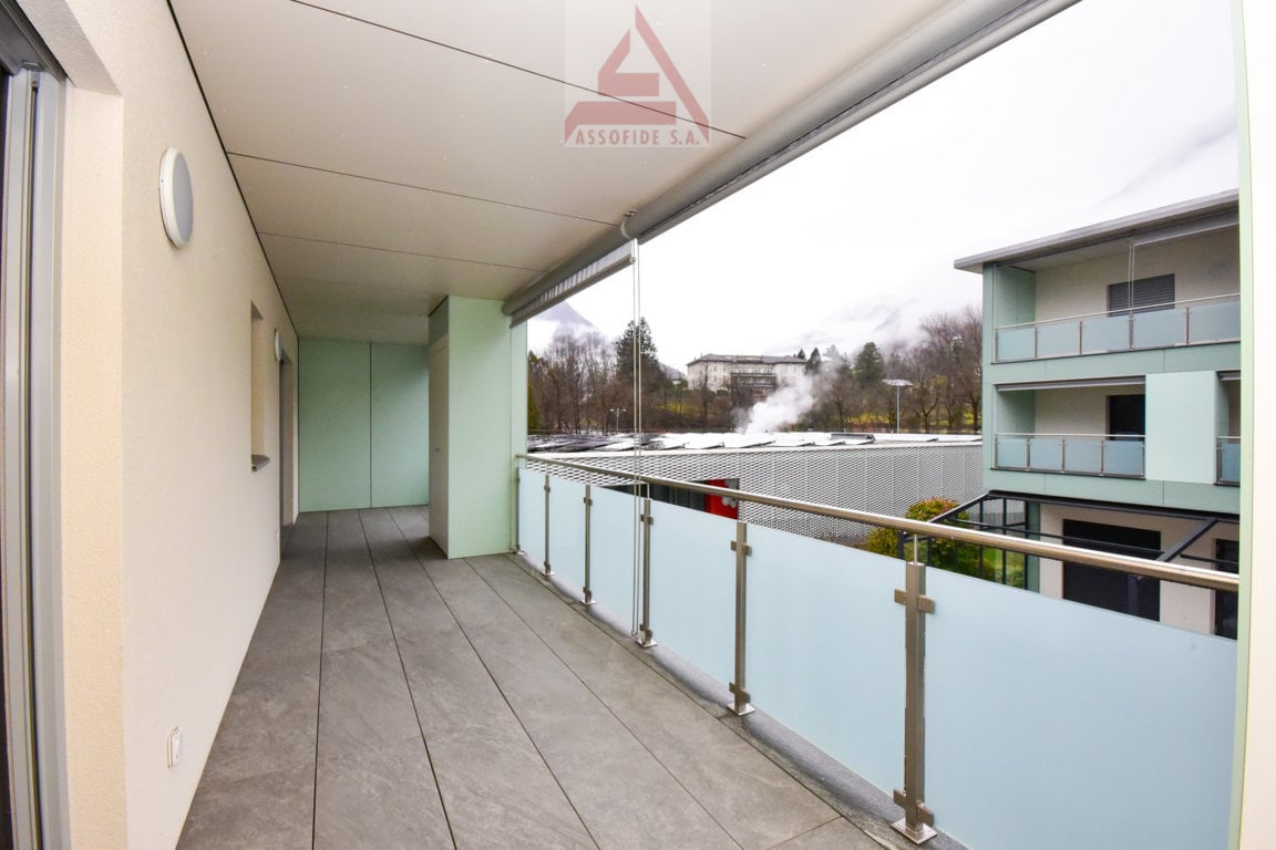 balcony with glass railing, view of mountains, tiled floor, walls, ceiling