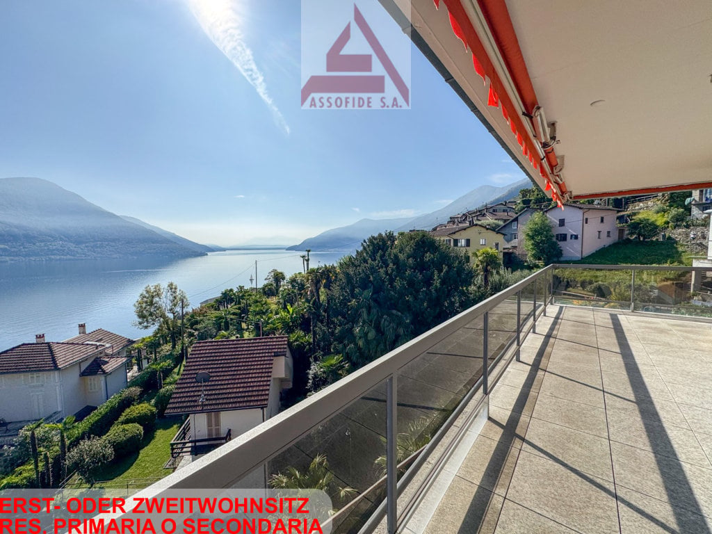 First or second home residence, balcony with glass railing, view of mountains and lake