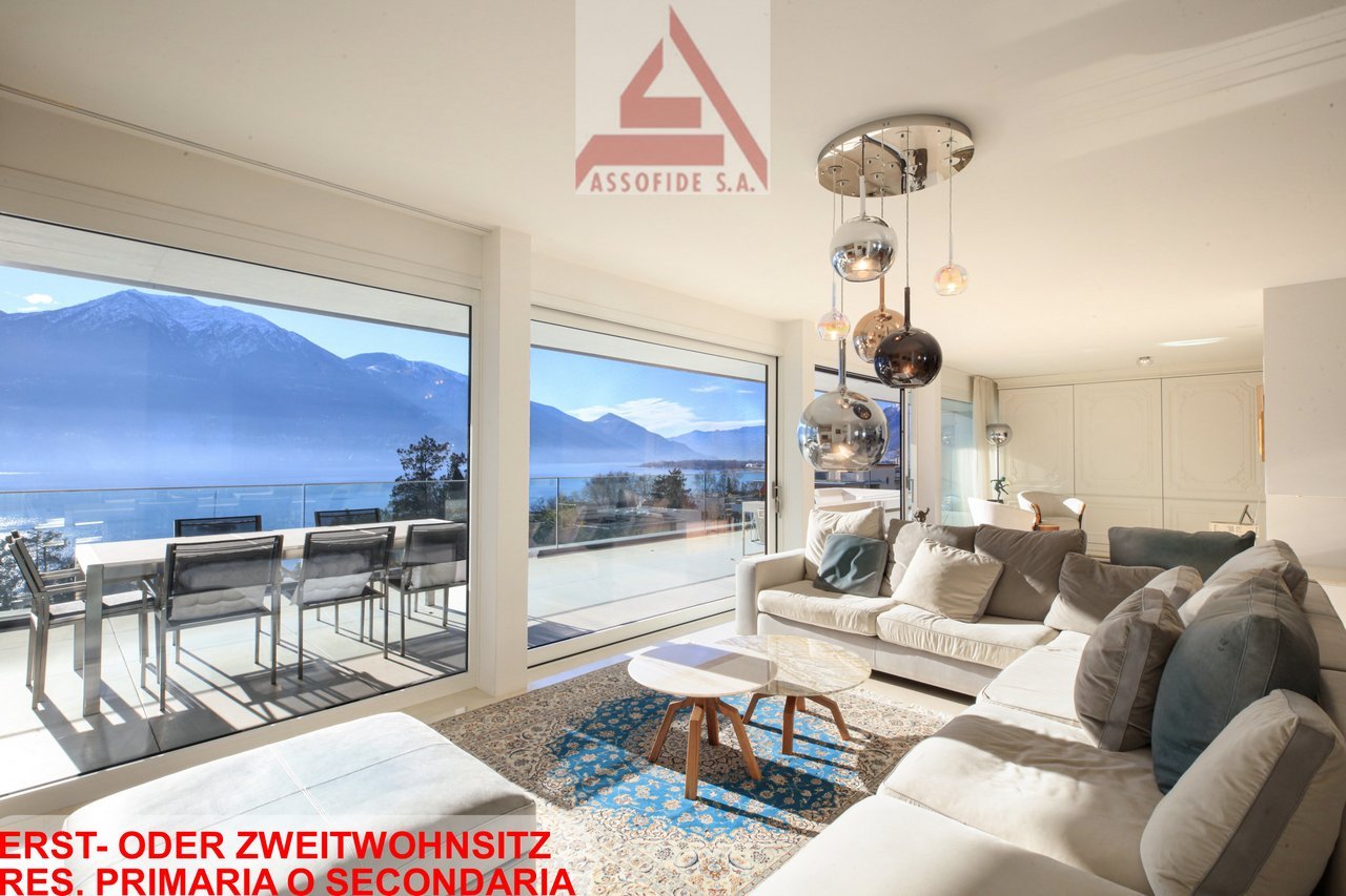 large windows, balcony, dining table, couch, coffee table, rug, chandelier