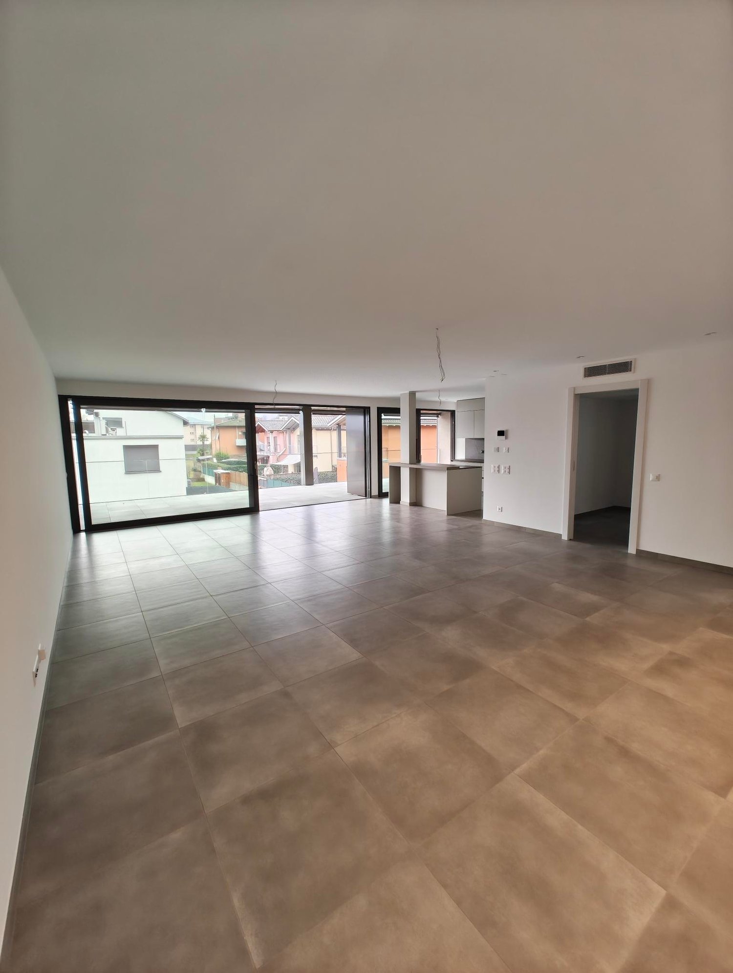 spacious open room, tile flooring, large windows, balcony