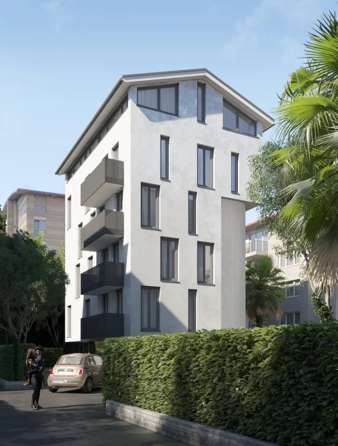 4-story modern apartment building with white exterior, large windows, and balconies. The building is surrounded by lush greenery and palm trees.