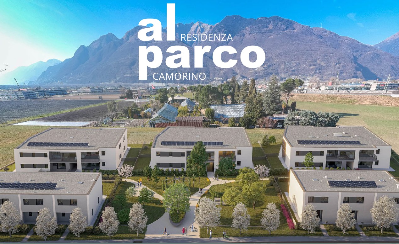 The image shows a residential complex called 'Al Parco Residenza' located in Camorino. The complex consists of several multi-story buildings with balconies and a large green area with trees and landscaping. There appear to be parking spaces available on t