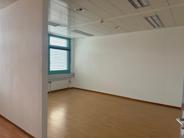 empty office room, windows, wooden floor, radiator
