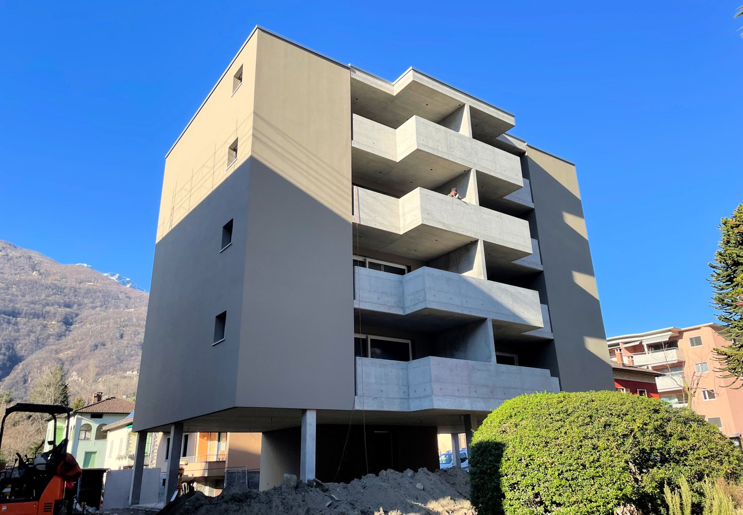 modern apartment building, balconies, 4 stories, basement parking, concrete balcony structures