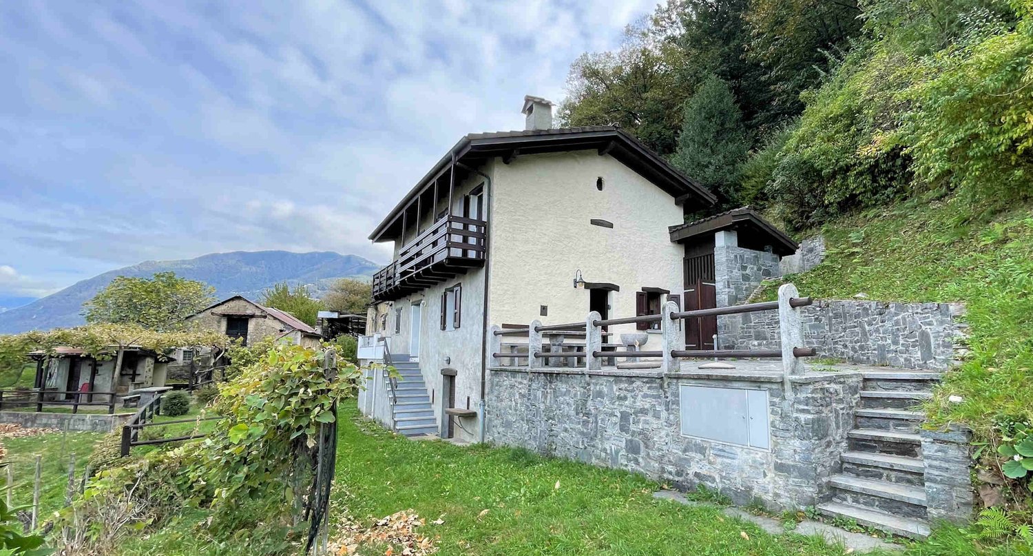 2 story house, stone wall, balcony, stairs, garden, mountain view