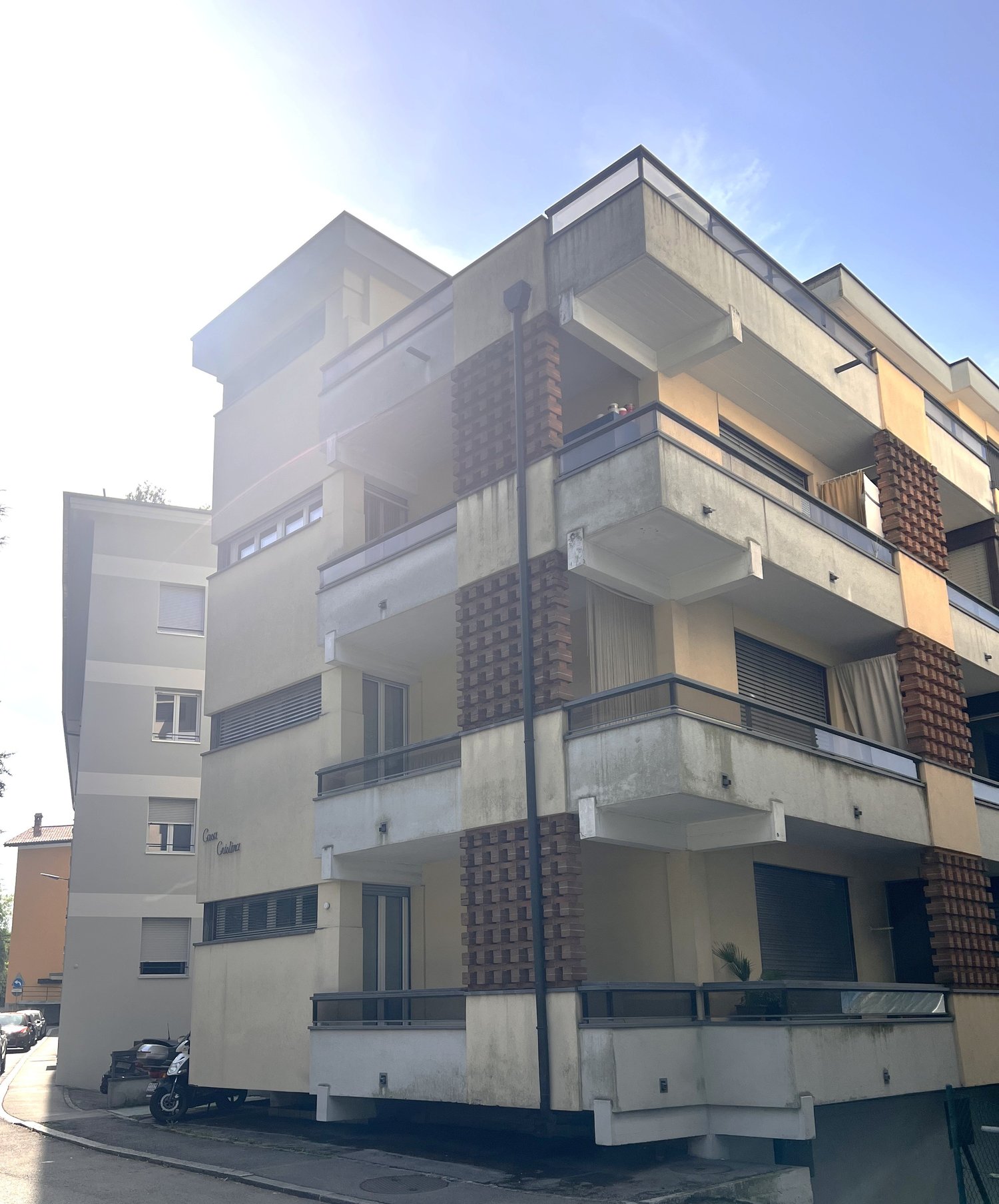 Multi-story apartment building with balconies, modern design, concrete and brick facade