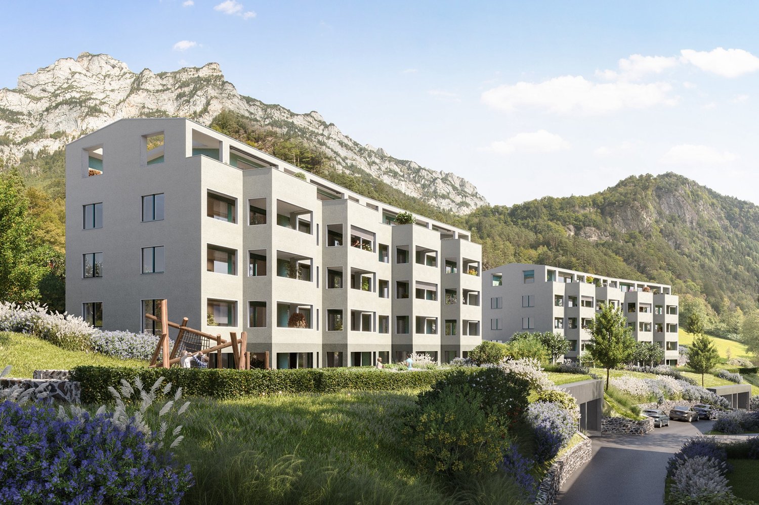 modern multistory building, surrounded by mountains, greenery, car access road, parking spaces