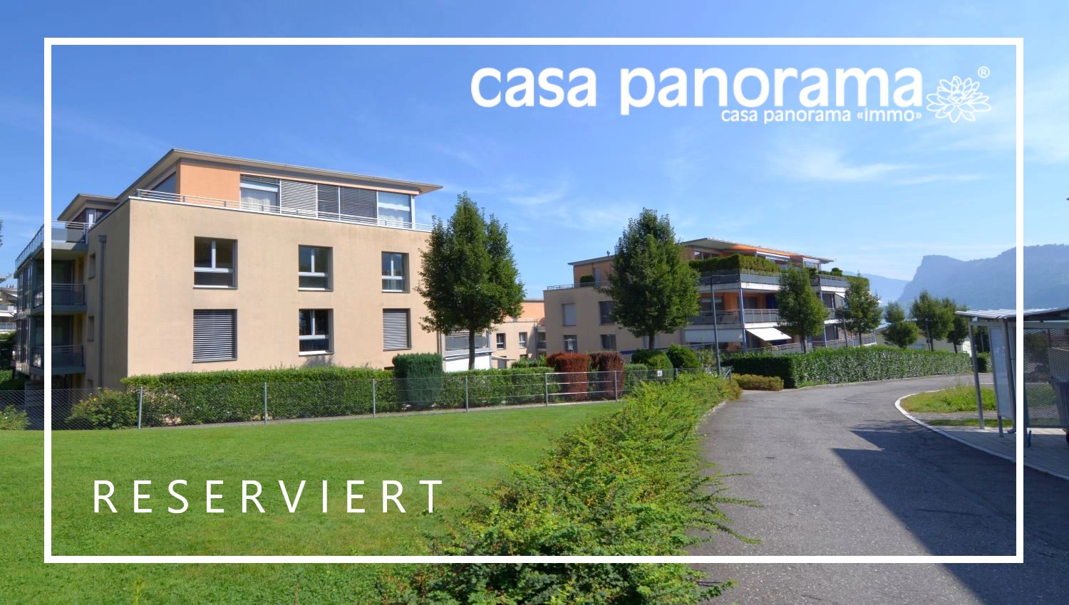 Apartment building with balconies, located in a quiet area, surrounded by trees and shrubs.