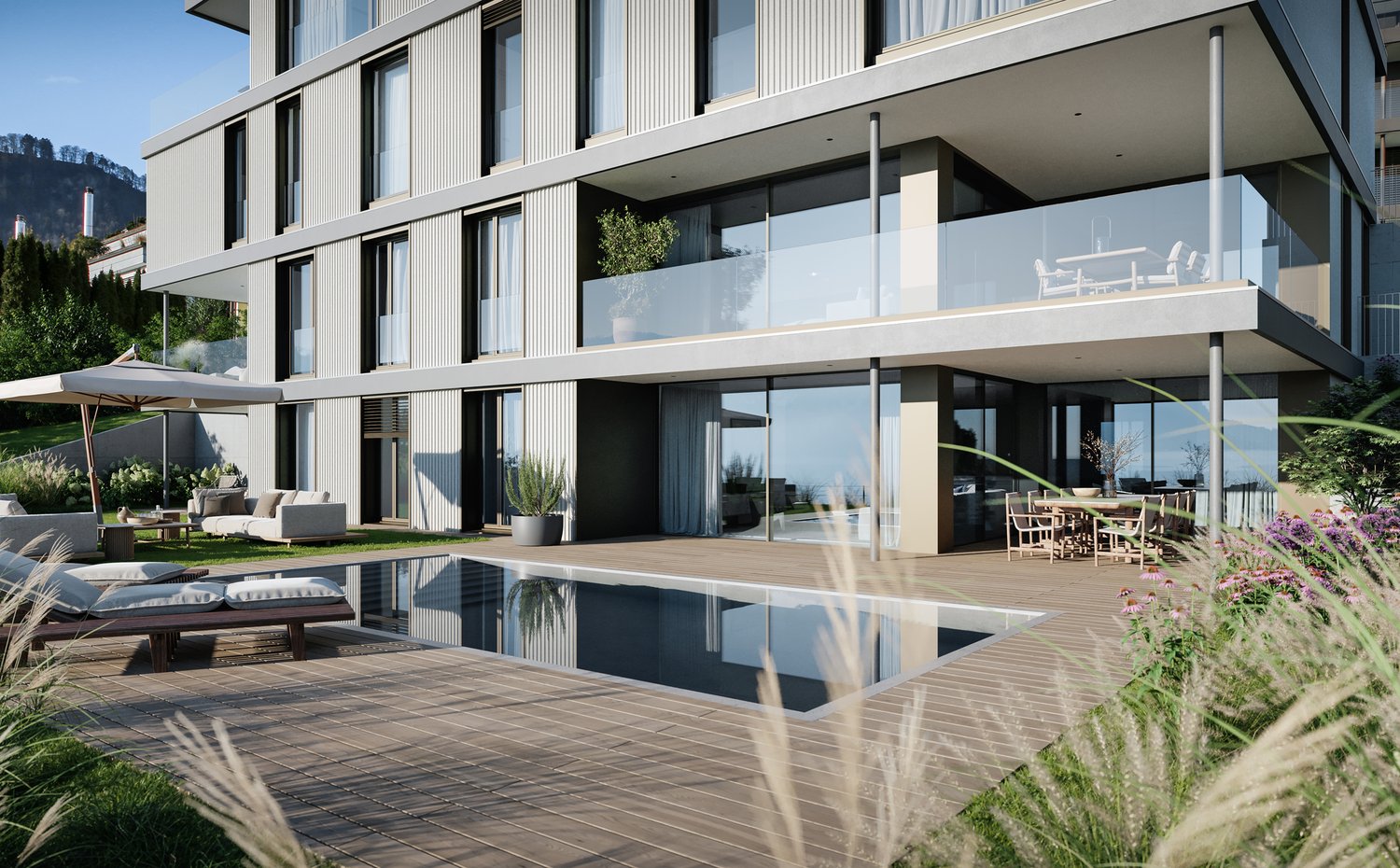 Modern multi-story building with large windows, balconies, and a swimming pool in the backyard. The building has a sleek, contemporary design with a mix of glass, metal, and wood materials. The outdoor area features a wooden deck, lounge chairs, and a wat