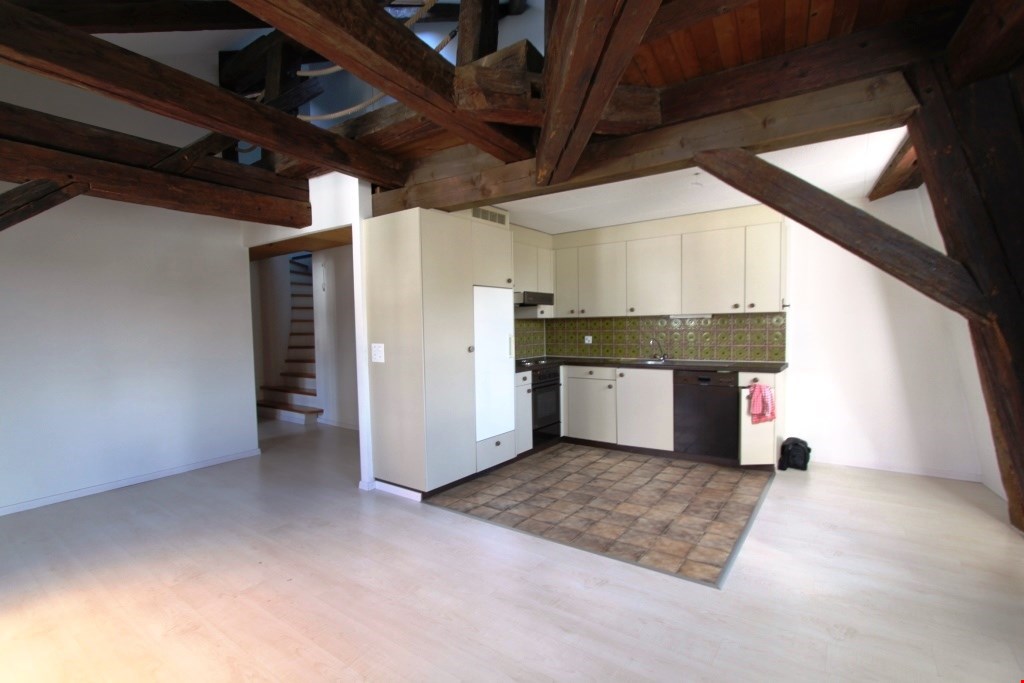 kitchen with wooden beams, white cabinets, tiled floor, dishwasher, sink, stove