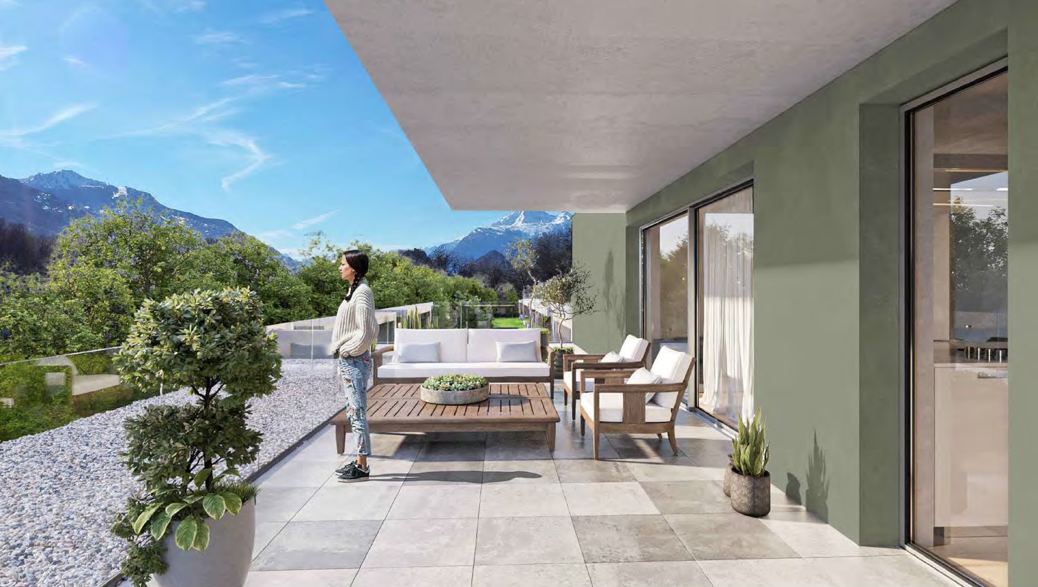 outdoor living space with couch, table, woman standing, potted plants, stone tiles, glass railing, mountains in the distance