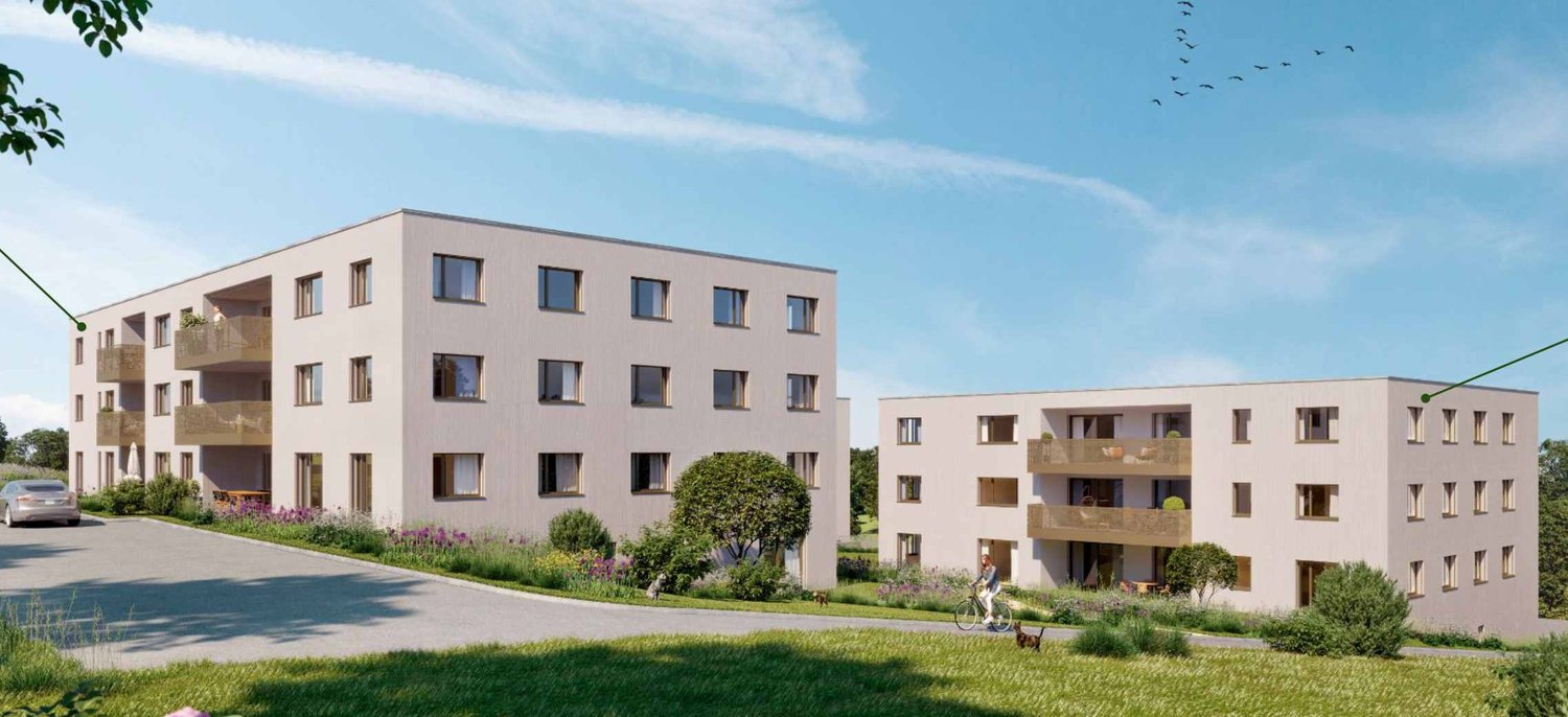 Two-story residential buildings with balconies, white exterior, parking area, greenery, car parked