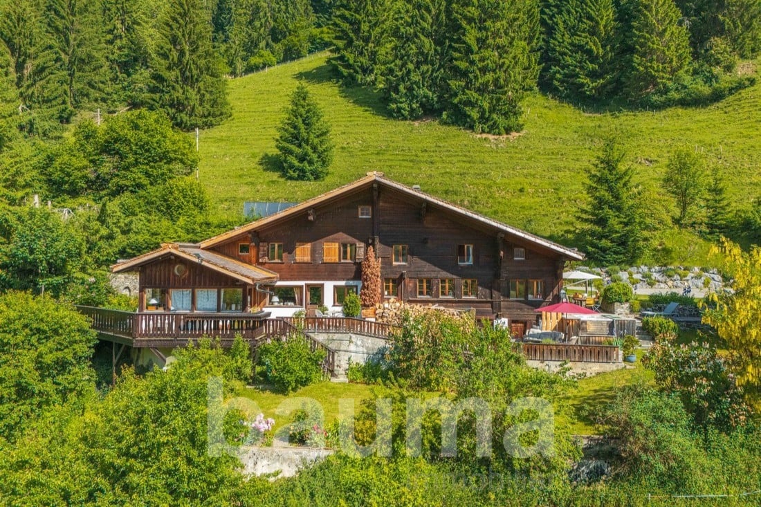 wooden house, hillside, large balcony, surrounded by green hills