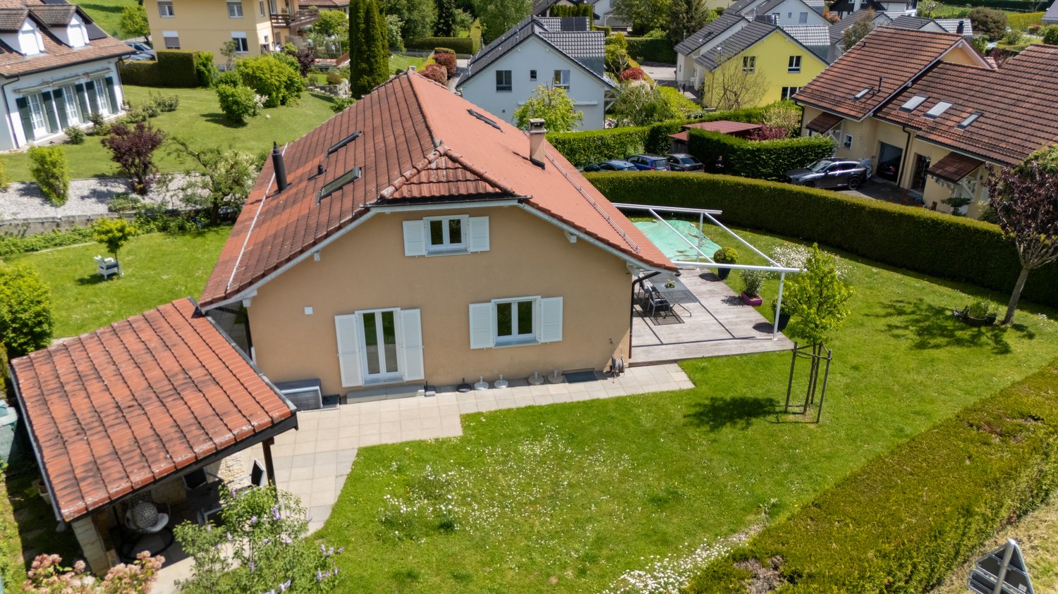 Single family house, red roof, brown exterior, garden, swimming pool, covered terrace, multiple windows, hedges, driveway