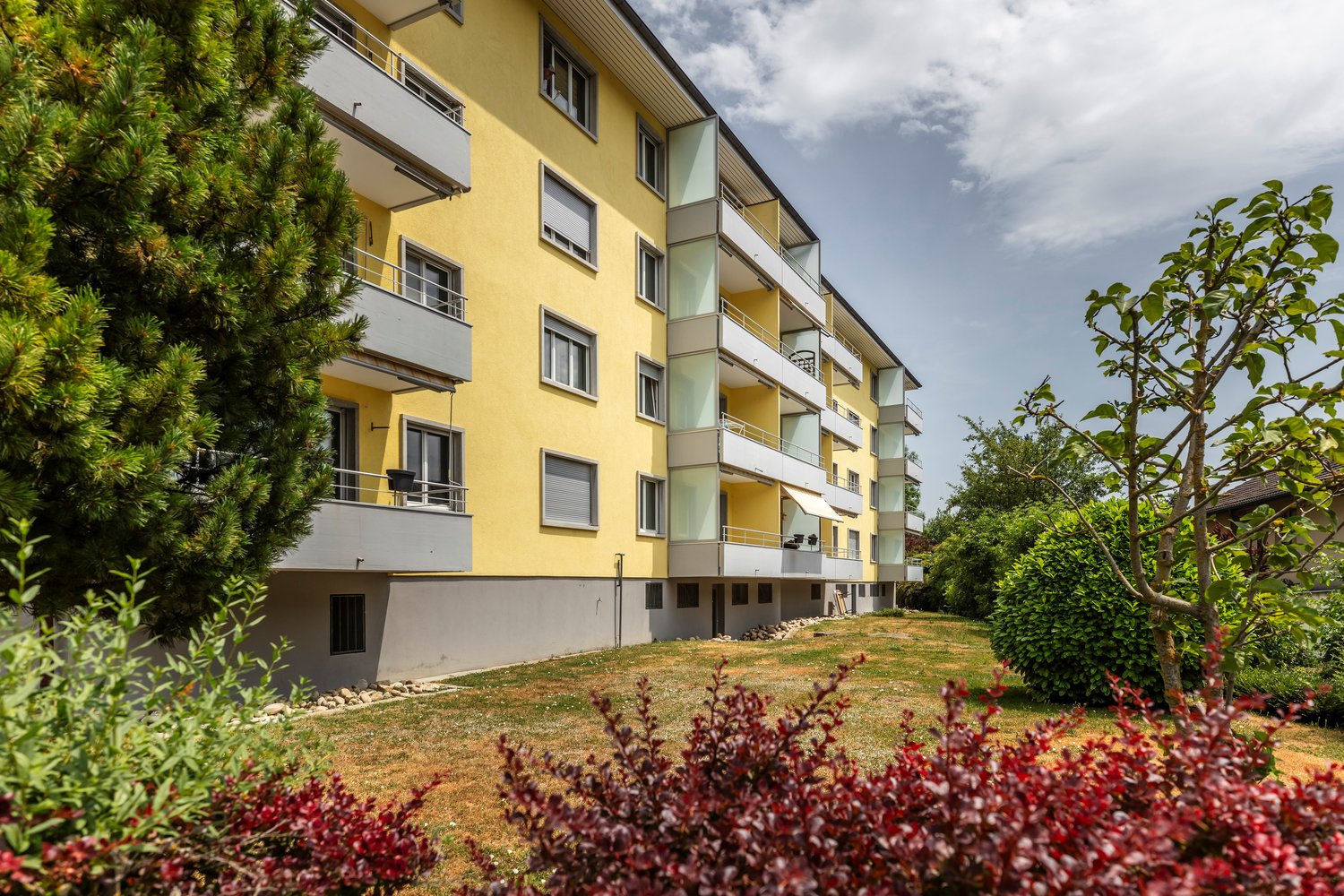 Yellow multi-story apartment building with balconies