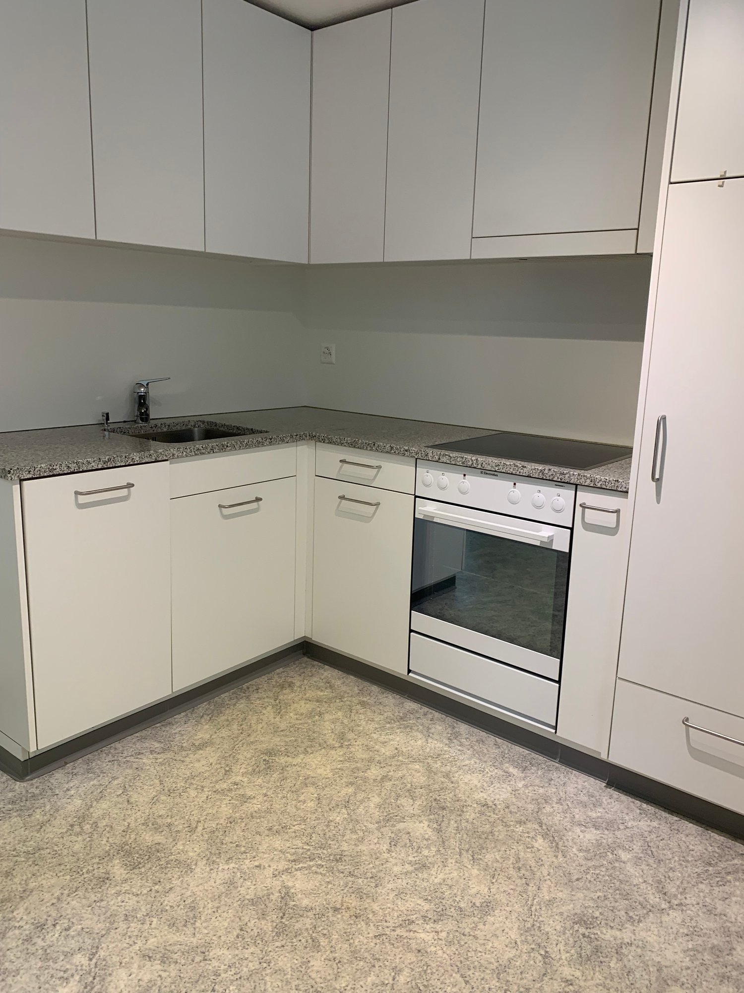 modern kitchen, white cabinets, granite countertop, stainless steel sink, electric stove, oven, under cabinet lights, power outlet