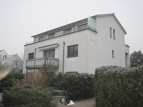 two story house, white exterior, balcony on the second floor