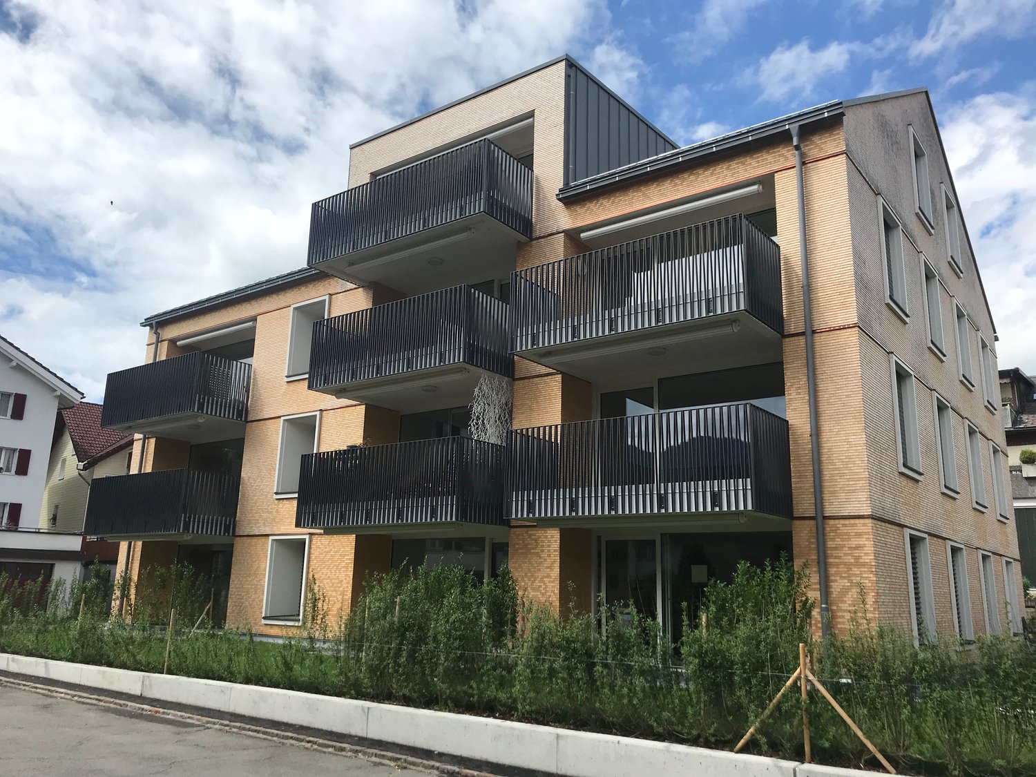 Modern apartment building with multiple balconies and glass windows