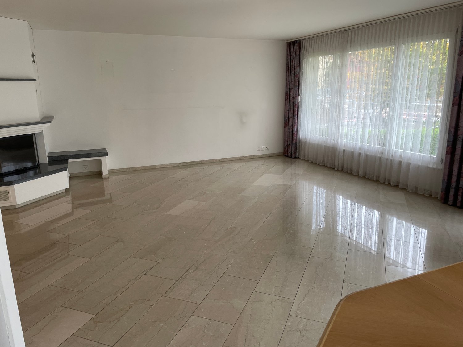 empty room, fireplace, tiled floor, white walls, large window, curtains