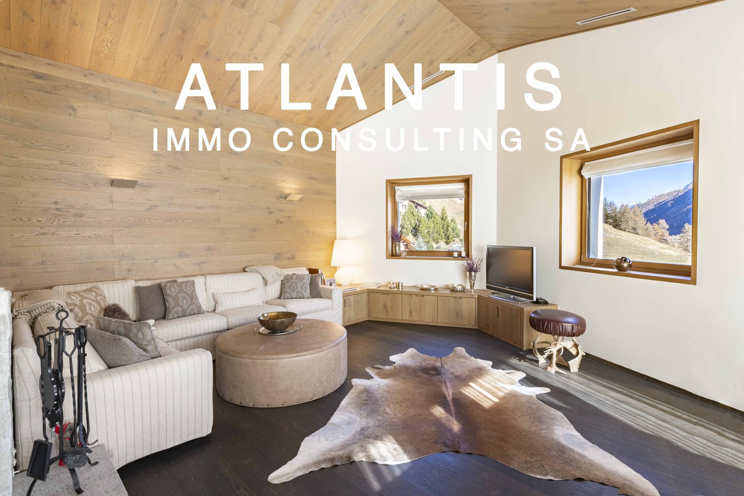 modern white sofa, wooden ceiling, hardwood floor, windows with view of mountains, television, wooden floor