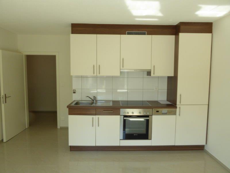 Spacious kitchen with white cabinets, wooden countertops, built-in oven and dishwasher