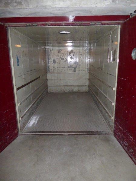 Empty garage space with two metal doors