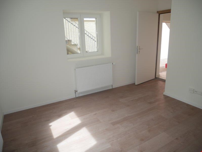 empty room, white walls, wooden floor, white radiator, window, open door