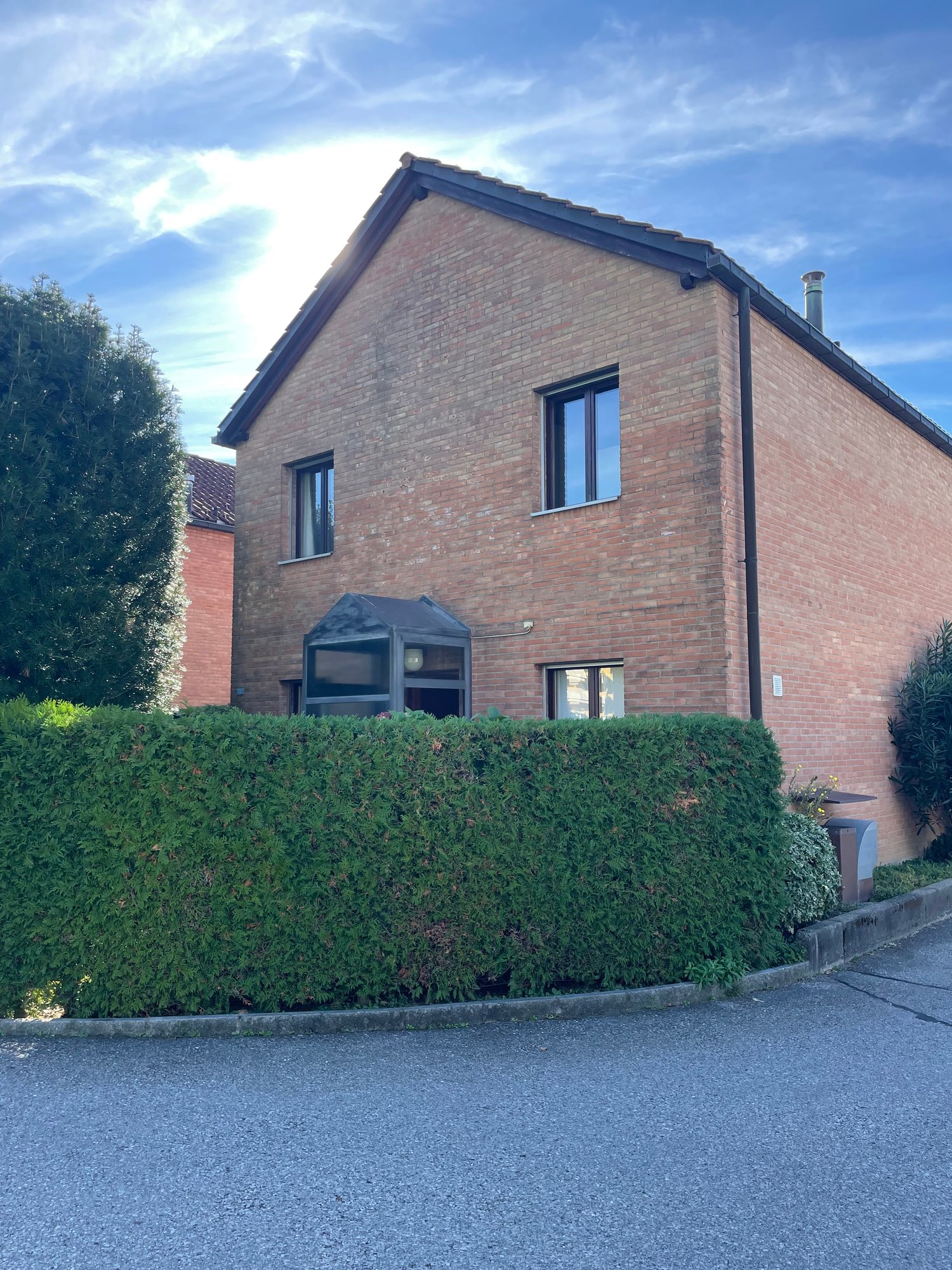 2 story house, brick exterior, 3 windows, glass doors, chimney