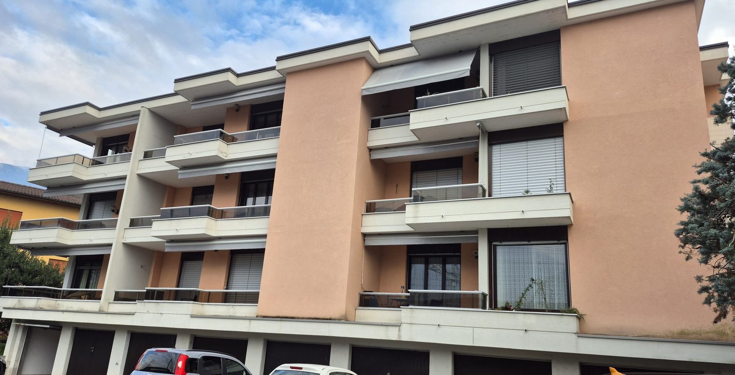 4 story apartment building, multiple balconies, underground garage