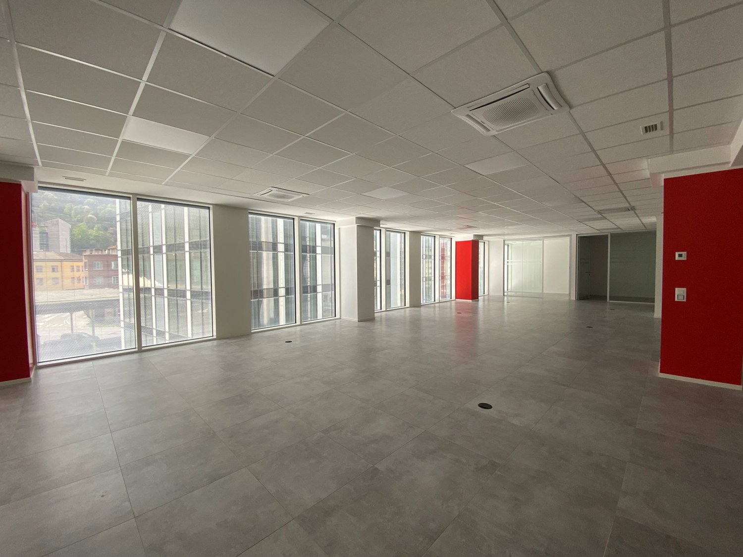 tiled floor, glass windows, two red columns, white ceiling, gray and white walls, ac vents