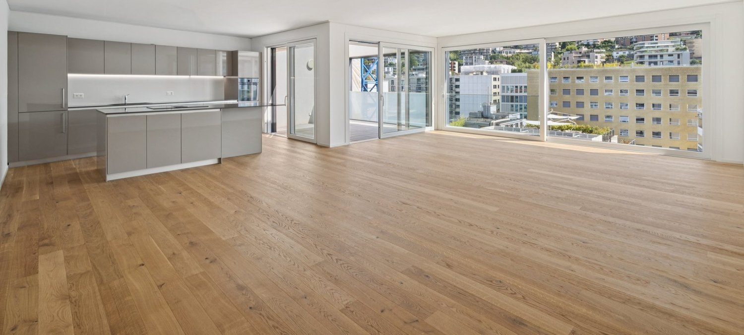 Open floor plan, modern kitchen, hardwood floors, kitchen island, glass sliding doors, balconies, panoramic city view