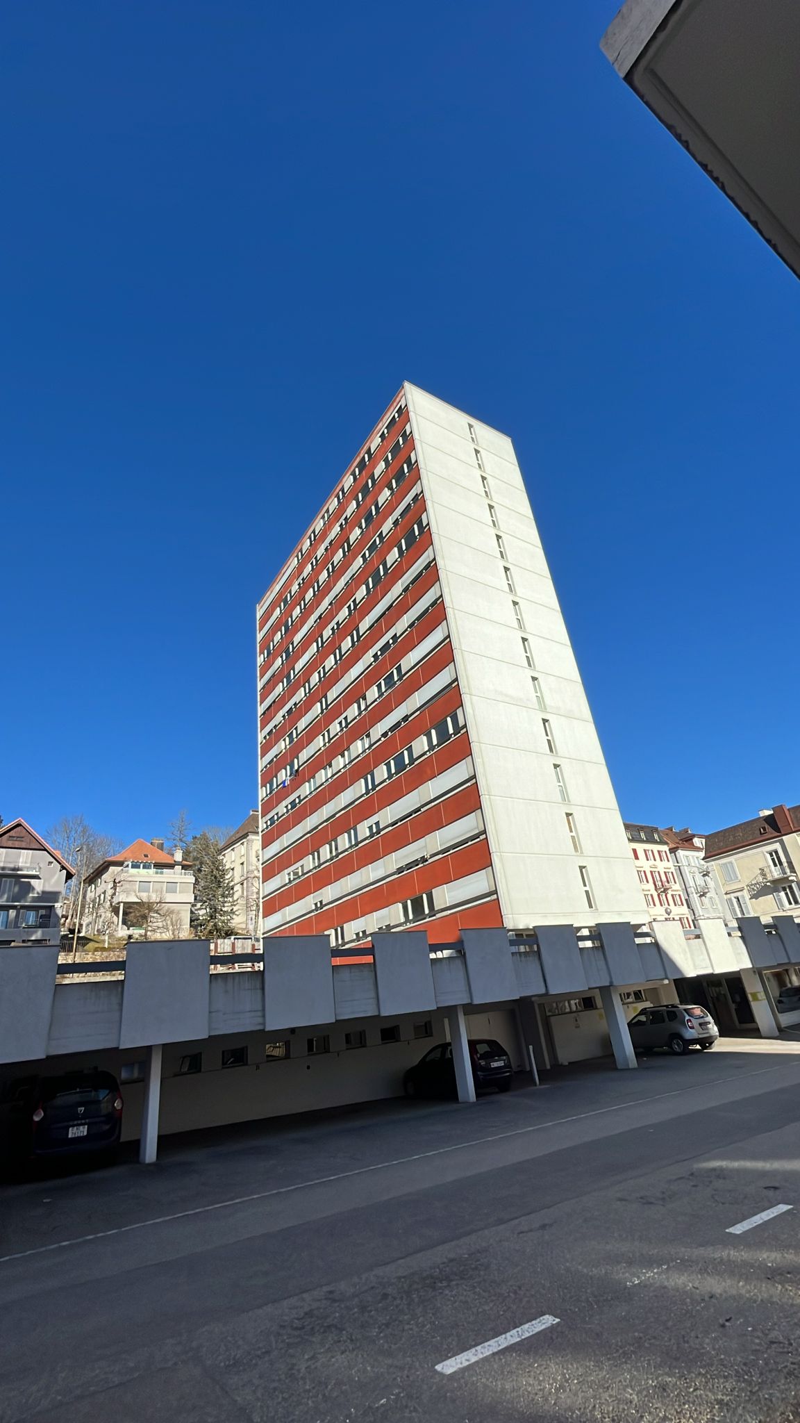 High-rise residential building, multi-level parking garage, underground parking