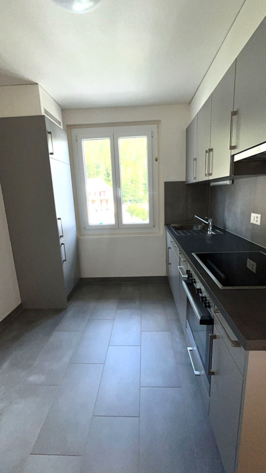 kitchen, gray tiles, window, sink, stove, cabinets