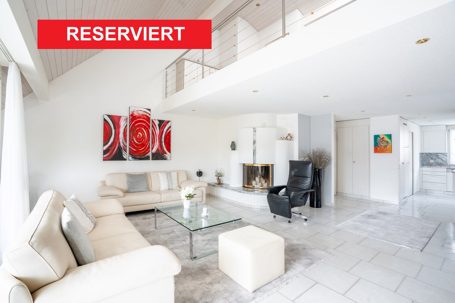 modern white interiors, large glass table, beige sofas, black leather chair, fireplace