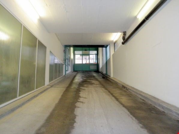 concrete floor, white walls, glass panels, lights on the ceiling