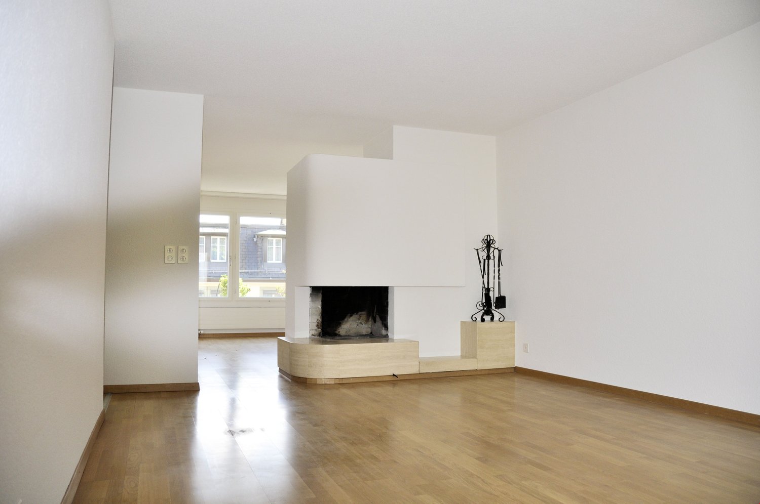 empty room, fireplace, wooden floor, white walls