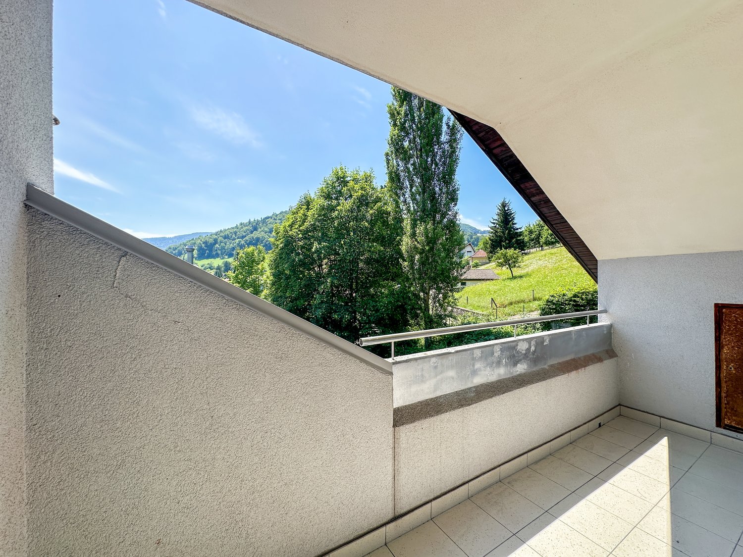 small balcony with tiled floor, steel railing, nice mountain view