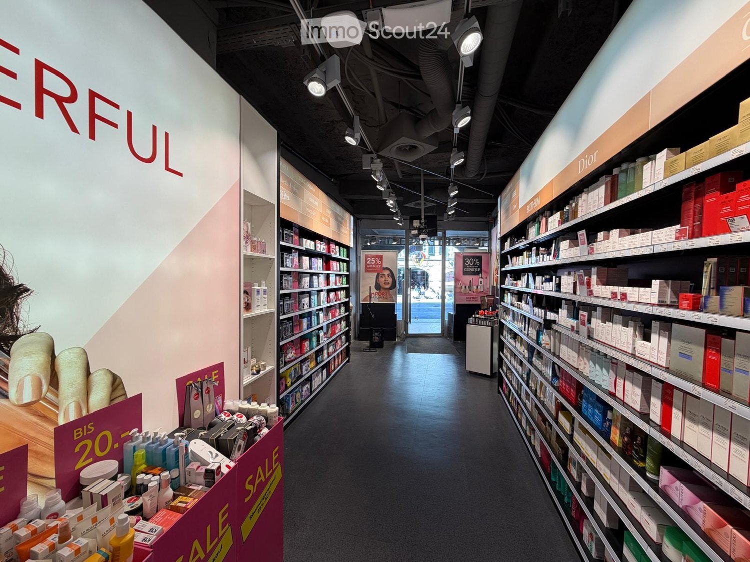 Cosmetics store with shelves full of products, sale signs, and a large wall with the word 'ERFUL'.
