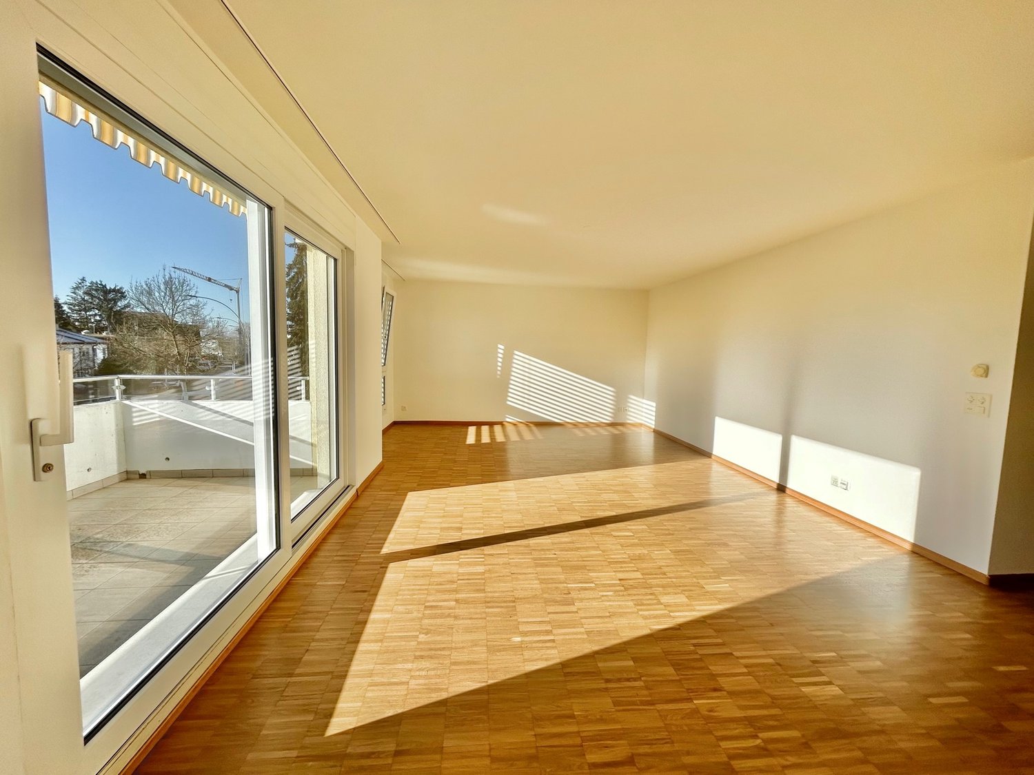 large windows, wooden floor, balcony, sunny, empty room