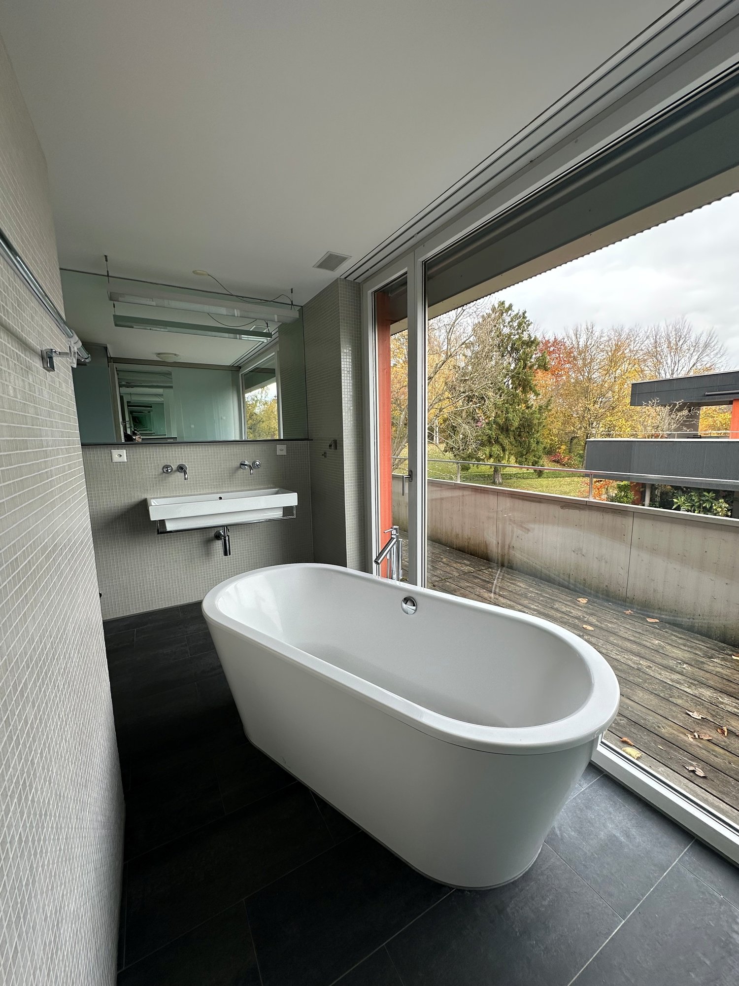 Bathtub, sink, large window, mirror