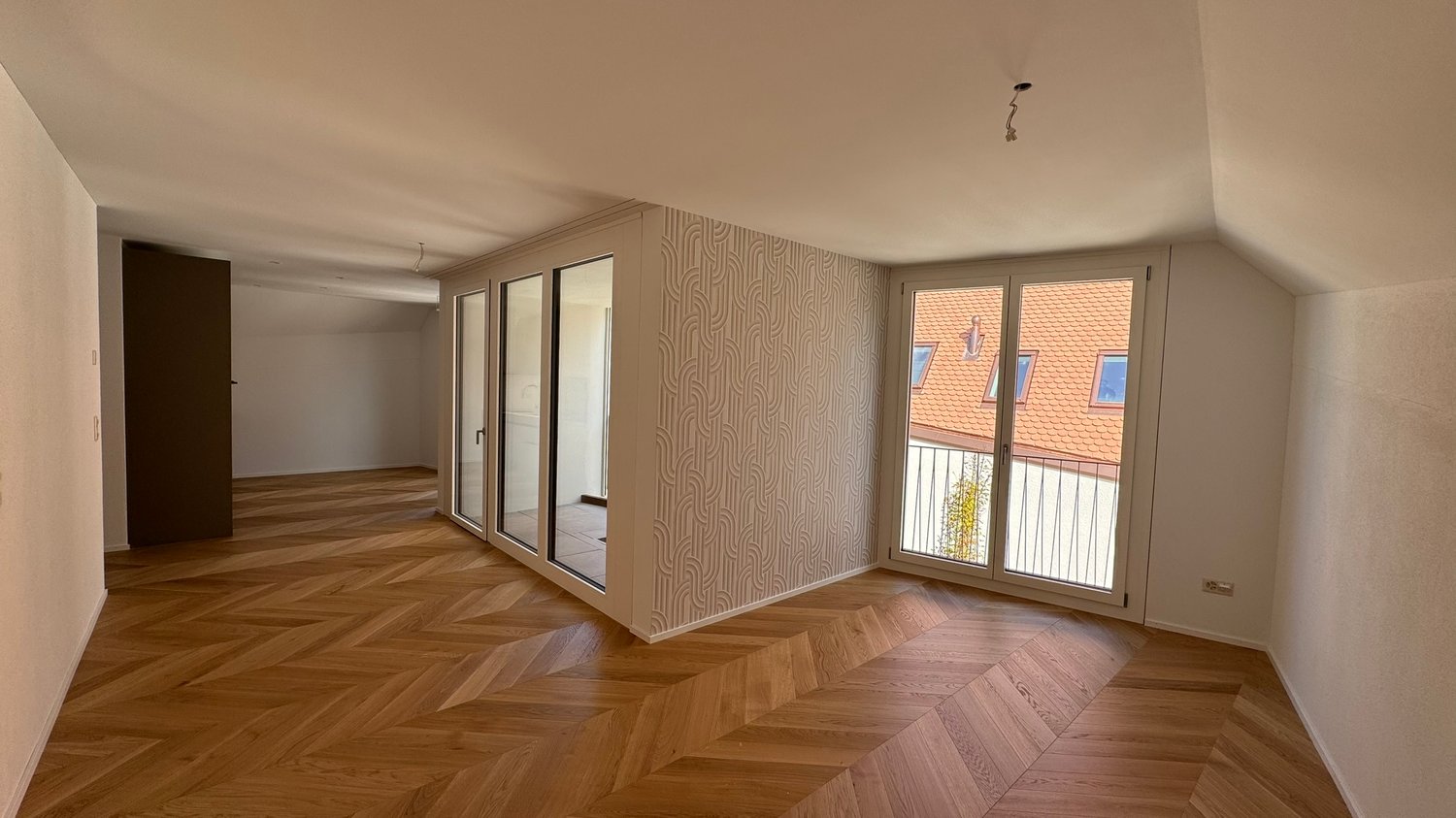 wide open room, wooden parquet floor, sliding doors to balcony, built-in wardrobe, wall design