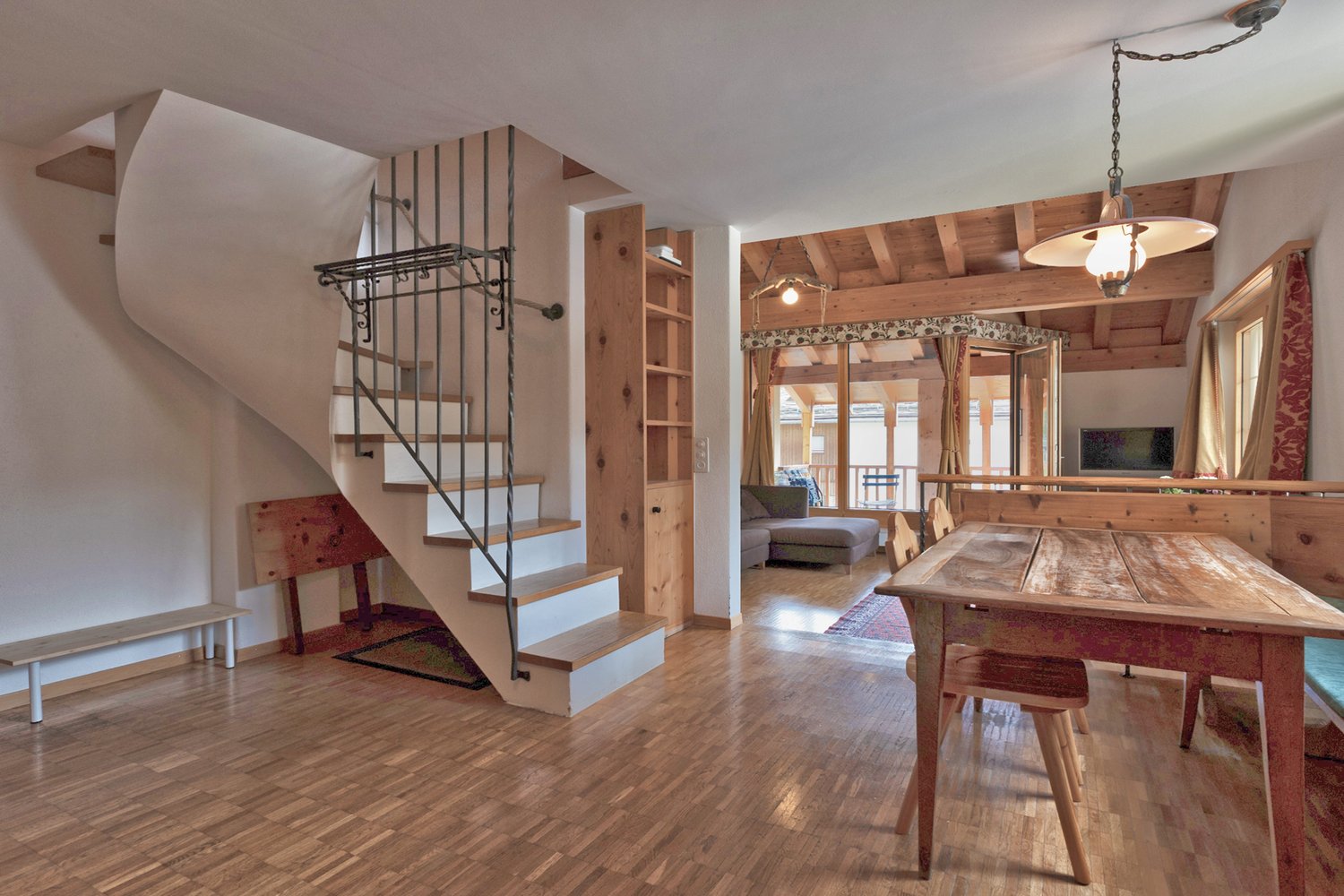 wood floor, dining area, spiral staircase, bench, wooden table