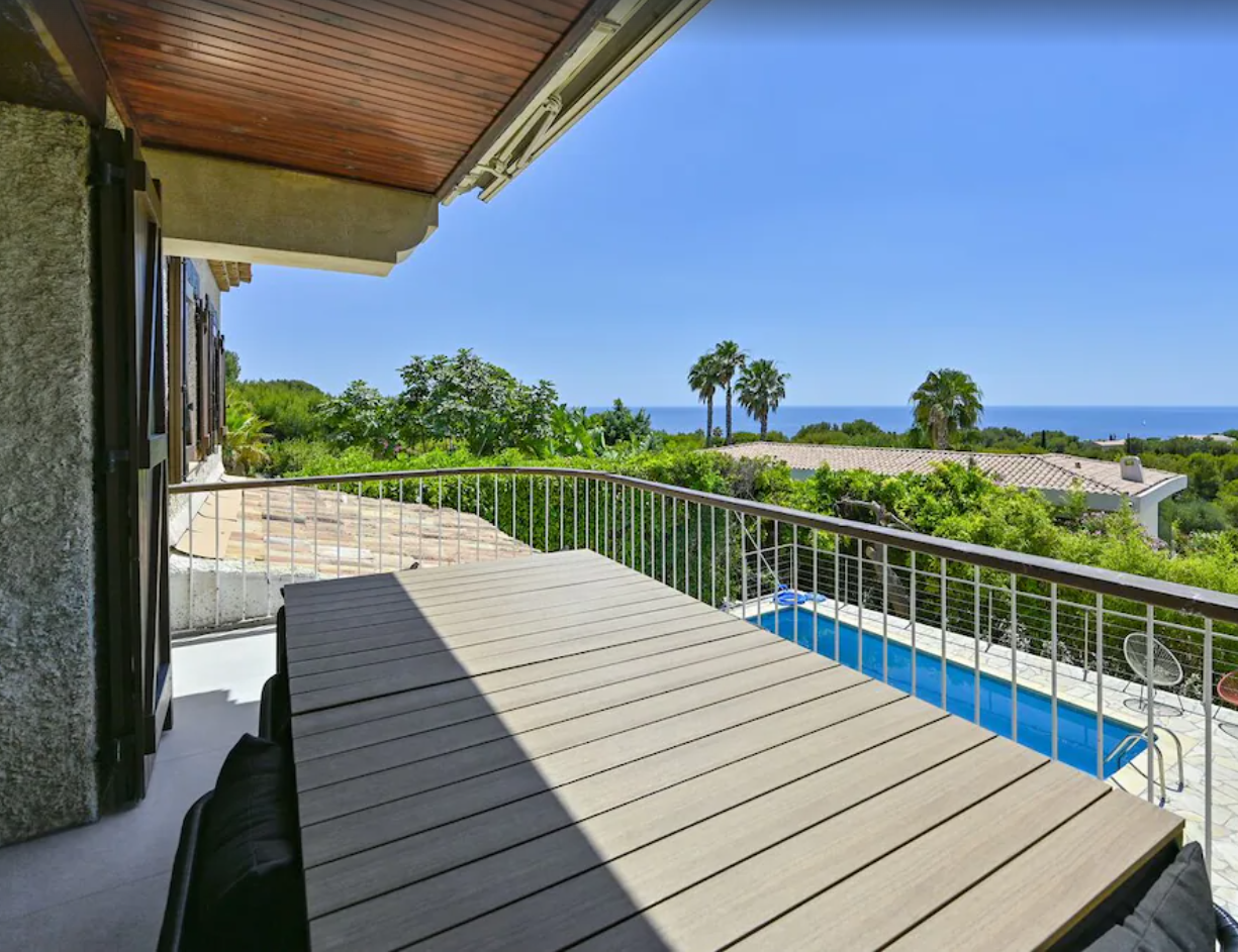 wooden terrace, metal railing, wooden table, swimming pool, sea view