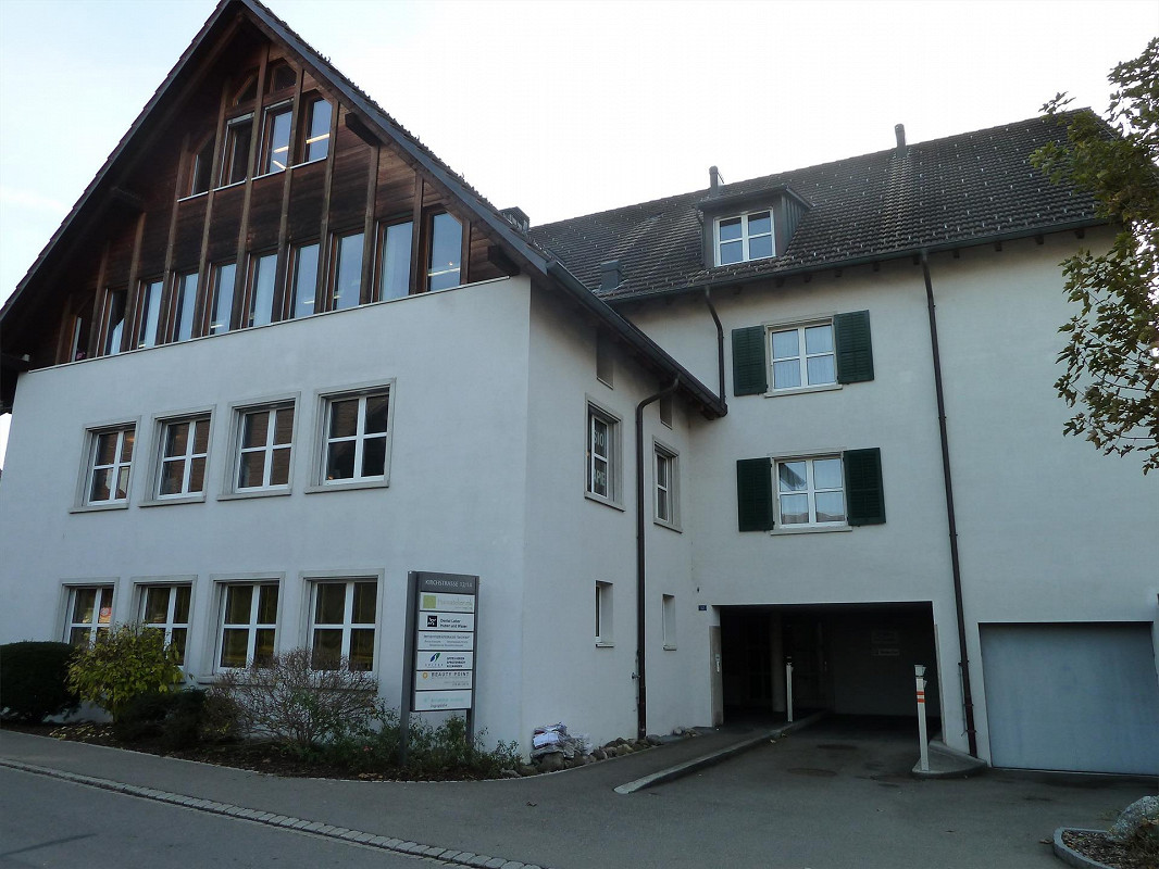 3 story house, white walls, wooden roof, multiple windows, garage