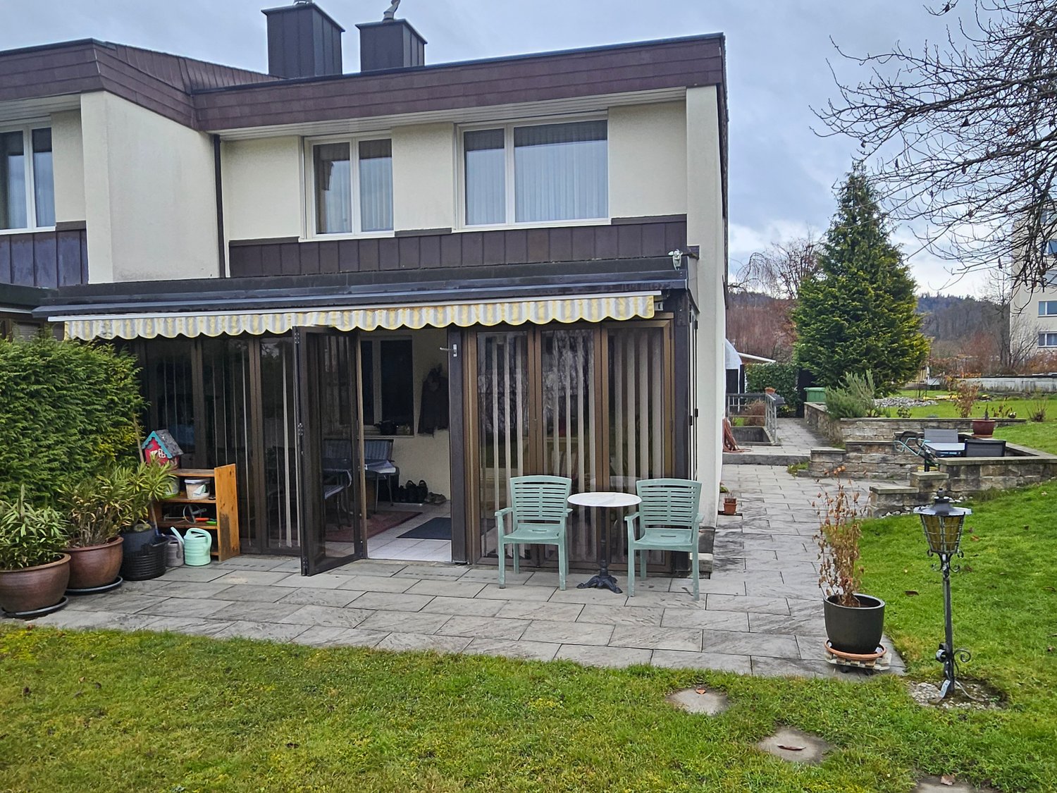 Modern terraced house, covered terrace, garden, outdoor table and chairs