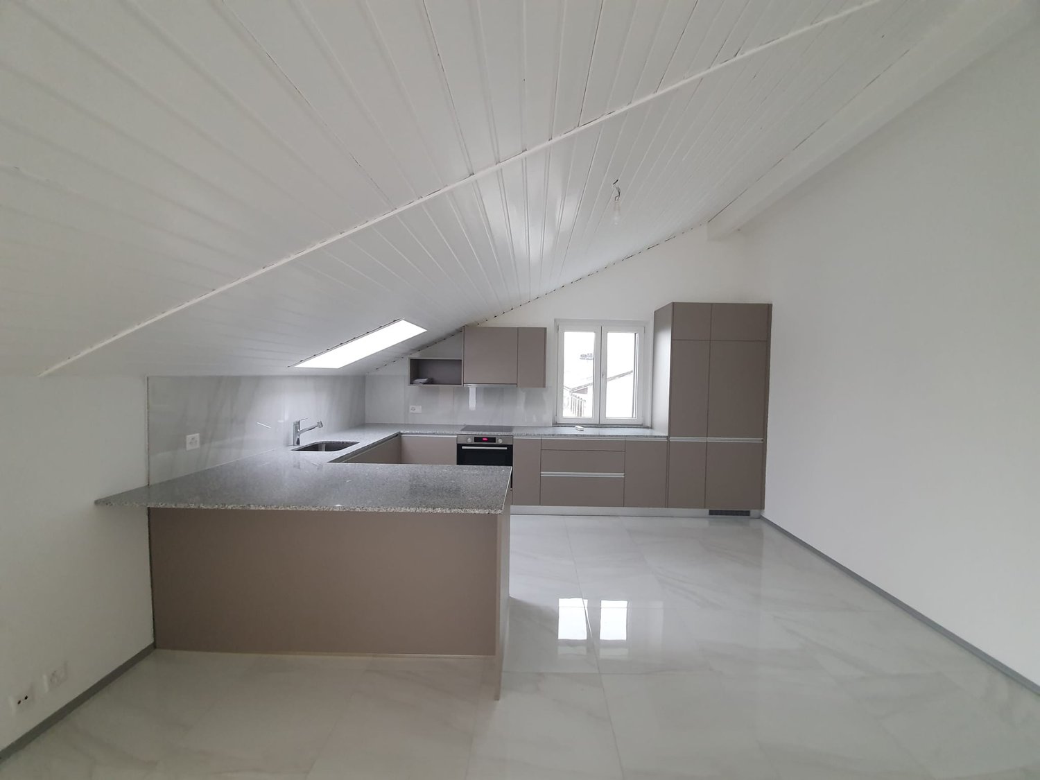 modern kitchen, gray countertops, white cabinets, stainless steel sink, electric stove, white walls, gray floor